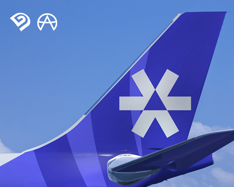 Close-up view of a SUM Air aircraft tail fin featuring the brand symbol applied to the vertical stabilizer against a clear blue sky.